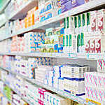 An aisle in a pharmacy. The commercial product(s) or designs displayed in this image represent simulations of a real product, and are changed or altered enough so that they are free of any copyright infringements. Our team of retouching and design specialists custom designed these elements for each photo shoot
