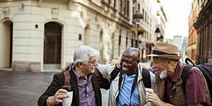 Close up of a group of male senior tourists exploring the city.