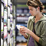 A man checking the expiration date on a bottle.