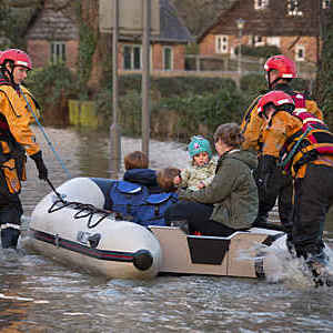 Family being rescued by the fire service after the River Derwent burst it's banks in the village of Old Malton England. 