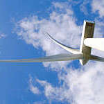 Wind turbines in mountain against sky.