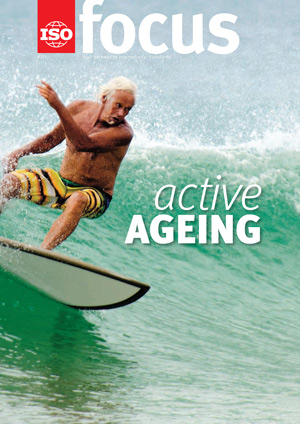 An elderly man wave surfing.